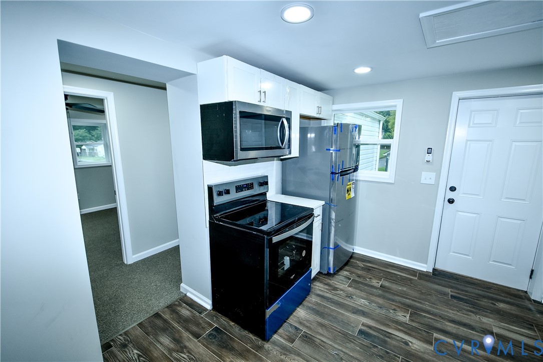 416 South Virginia Street Farmville, VA 23901 - Photo 4 of 33 a kitchen with stainless steel appliances granite countertop a stove a refrigerator and a microwave