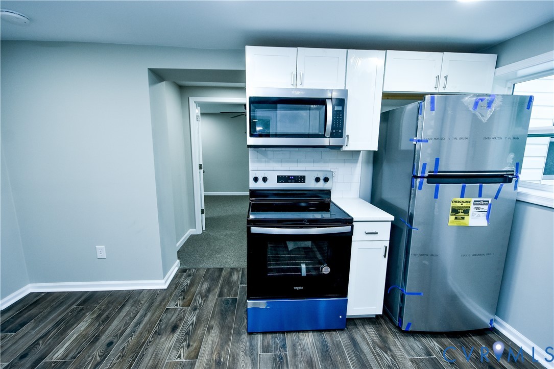 416 South Virginia Street Farmville, VA 23901 - Photo 7 of 33 a kitchen with stainless steel appliances granite countertop a stove a refrigerator and a microwave