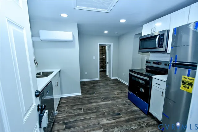 a kitchen with sink microwave and refrigerator