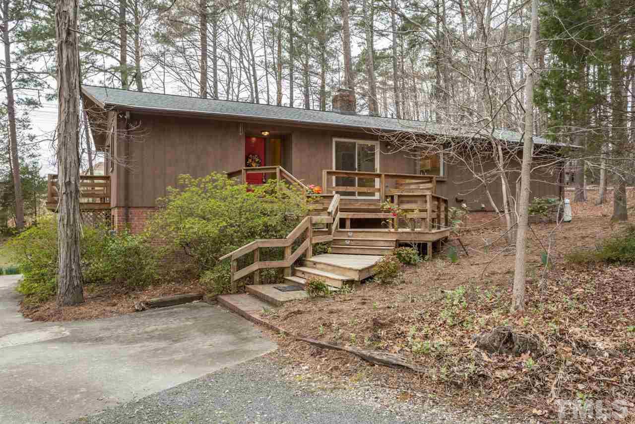 6701 Laurdane Road Raleigh, NC 27613 - Photo 1 of 24 a front view of a house with garden