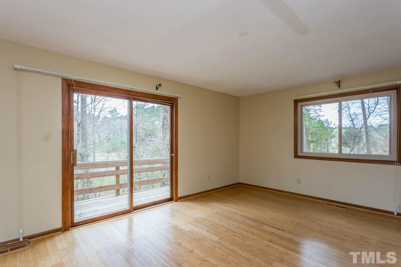 6701 Laurdane Road Raleigh, NC 27613 - Photo 11 of 24 an empty room with wooden floor and windows
