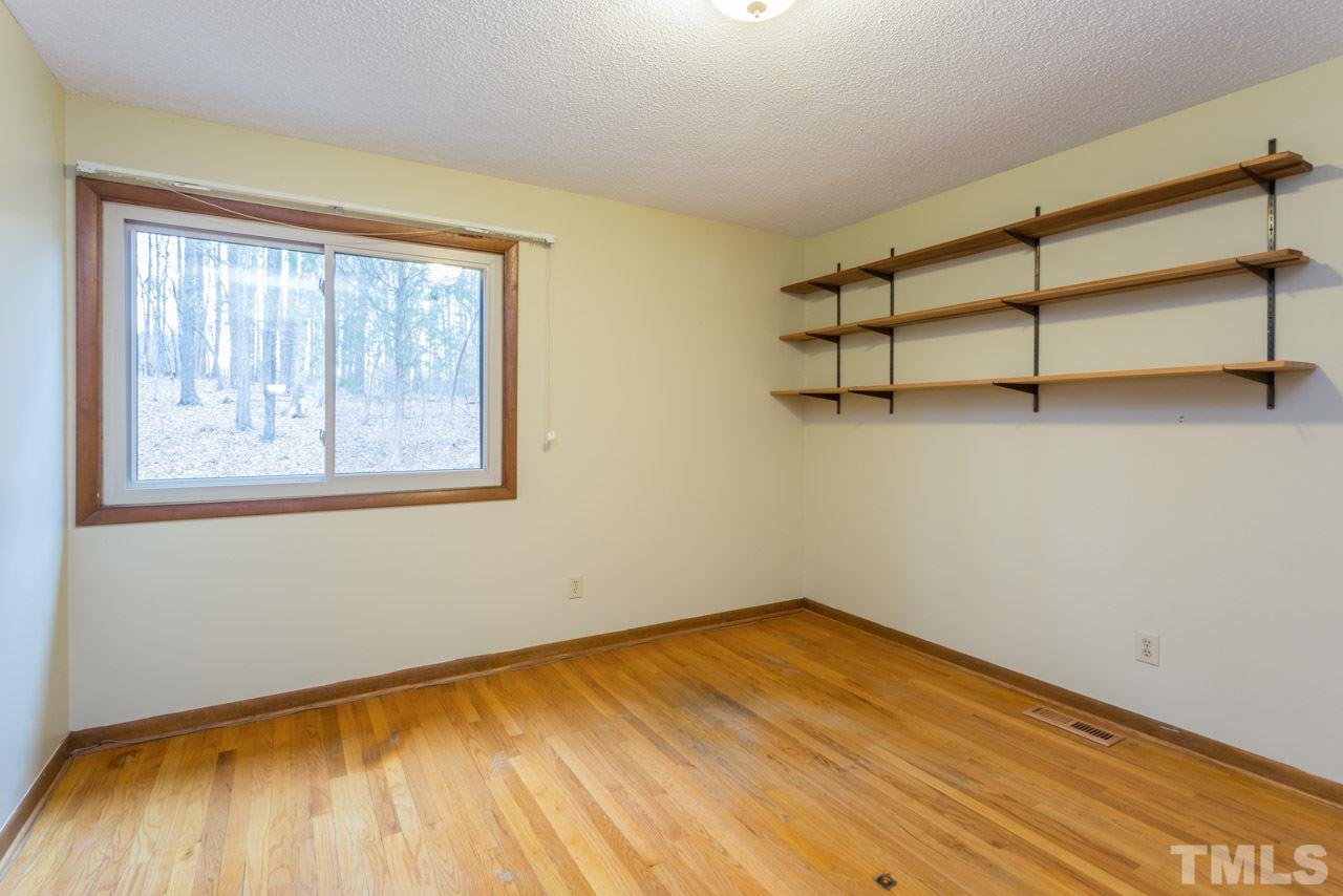 6701 Laurdane Road Raleigh, NC 27613 - Photo 12 of 24 a view of empty room with wooden floor and fan