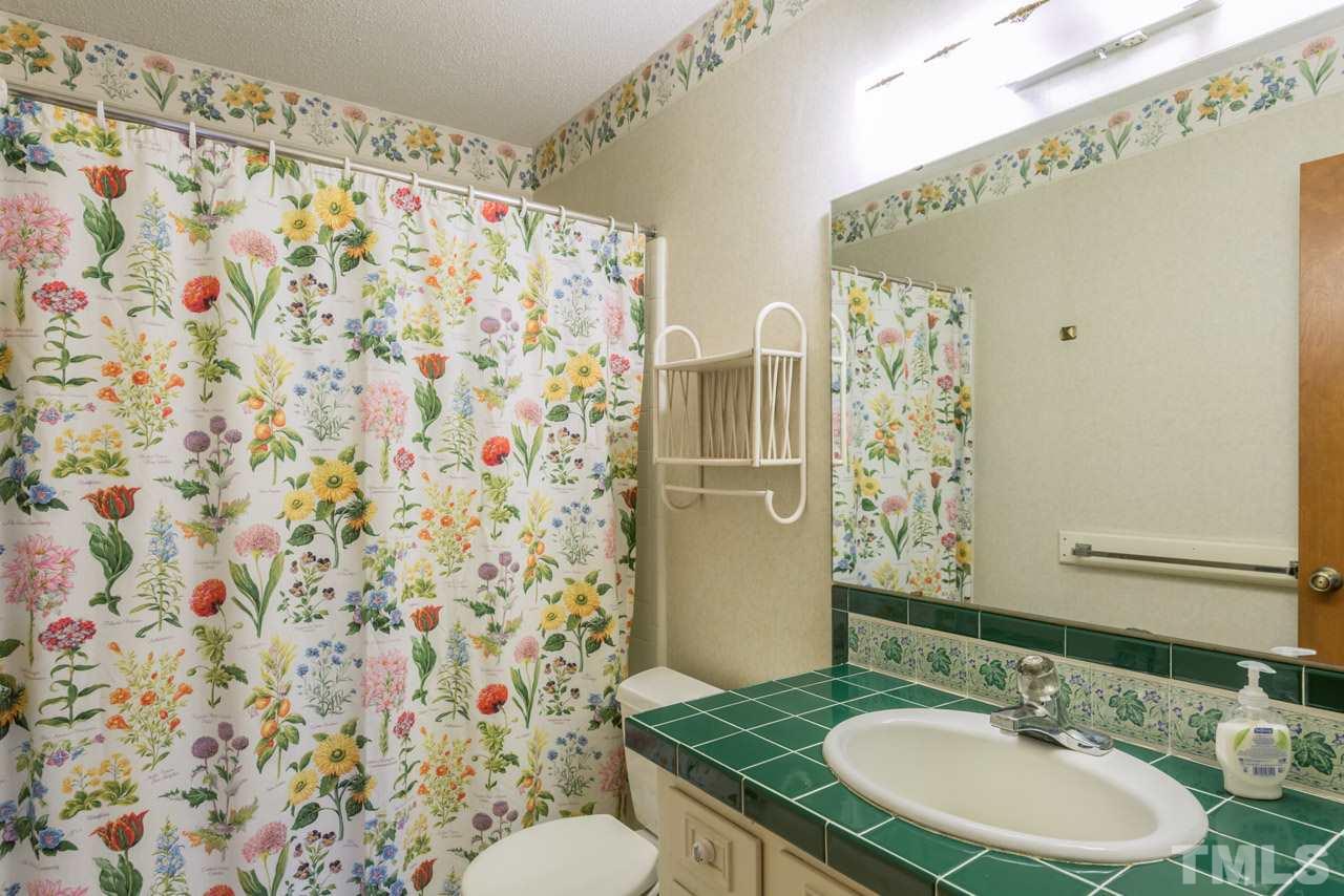 6701 Laurdane Road Raleigh, NC 27613 - Photo 13 of 24 a bathroom with a sink and a mirror