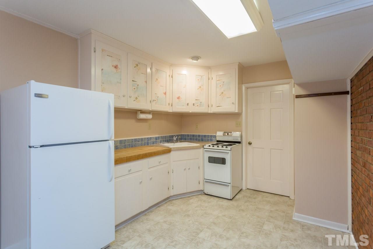 6701 Laurdane Road Raleigh, NC 27613 - Photo 17 of 24 a white refrigerator freezer sitting in a kitchen