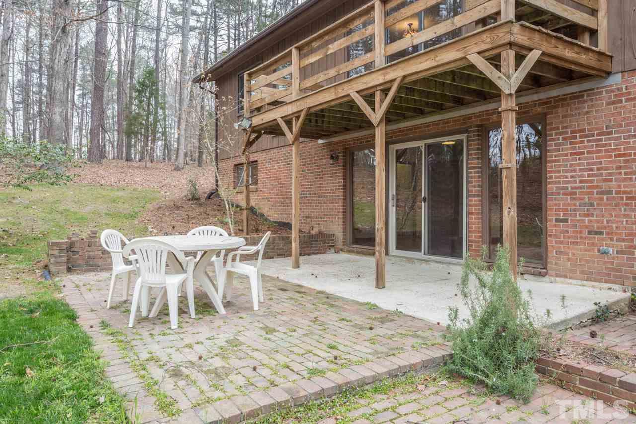 6701 Laurdane Road Raleigh, NC 27613 - Photo 21 of 24 a view of a patio with table and chairs and potted plants