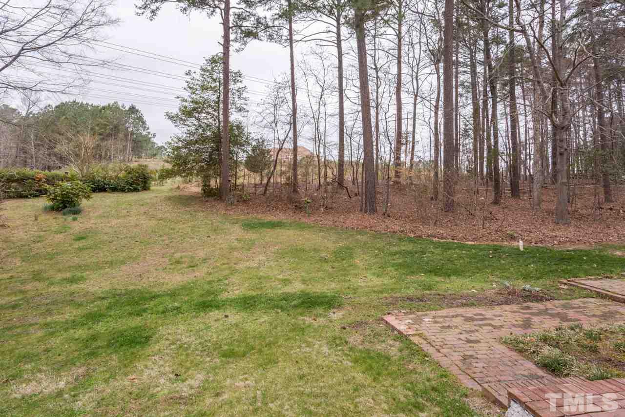6701 Laurdane Road Raleigh, NC 27613 - Photo 24 of 24 a backyard of a house with lots of green space