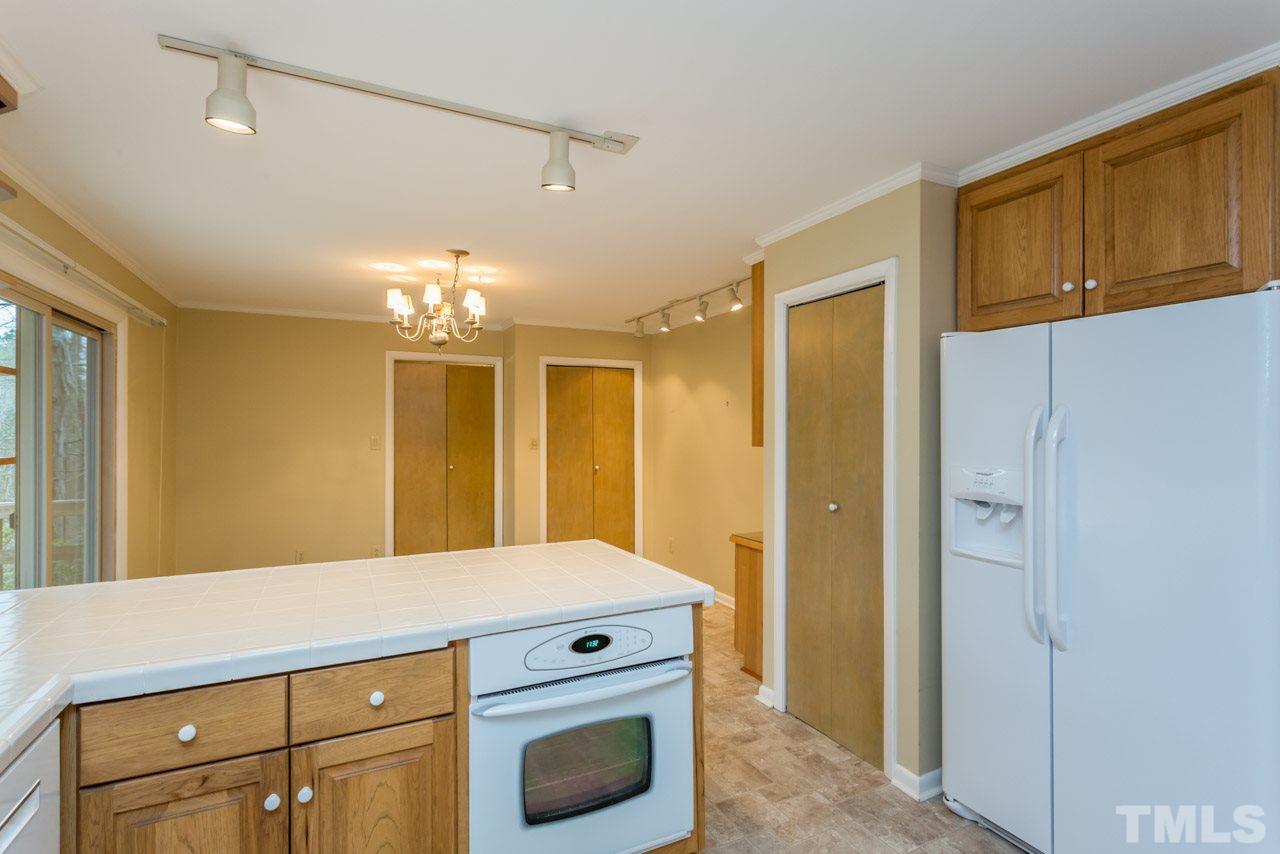 6701 Laurdane Road Raleigh, NC 27613 - Photo 5 of 24 a kitchen with a refrigerator and a sink