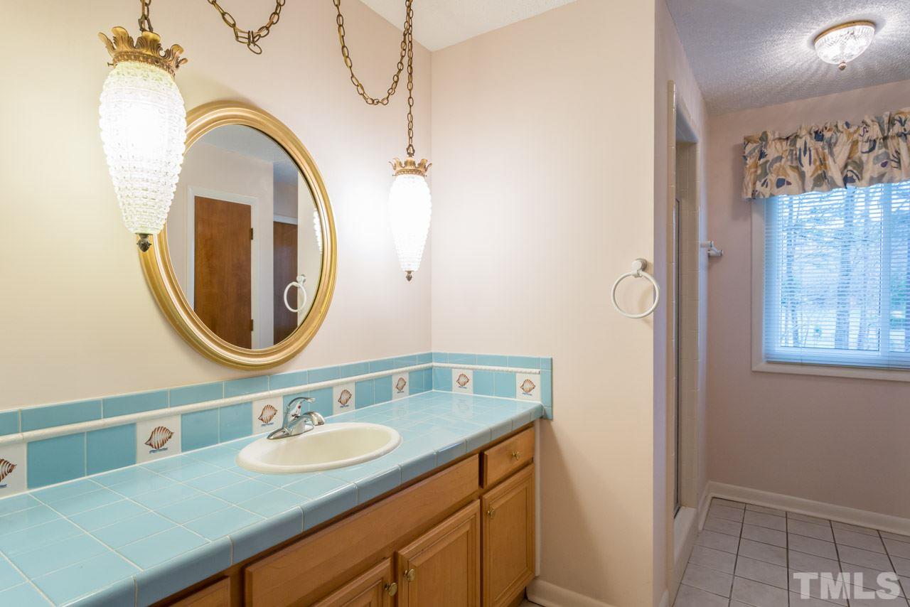6701 Laurdane Road Raleigh, NC 27613 - Photo 10 of 24 a bathroom with a granite countertop double vanity sink and a mirror