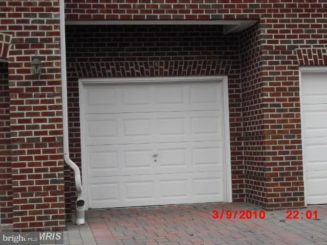a kitchen with a sink a refrigerator and cabinets
