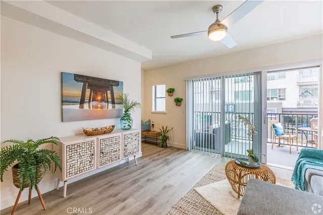 a living room with furniture and a floor to ceiling window