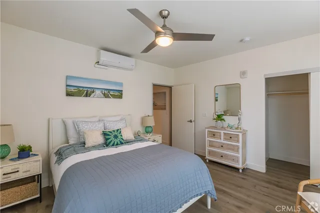 a bedroom with a bed and a dresser