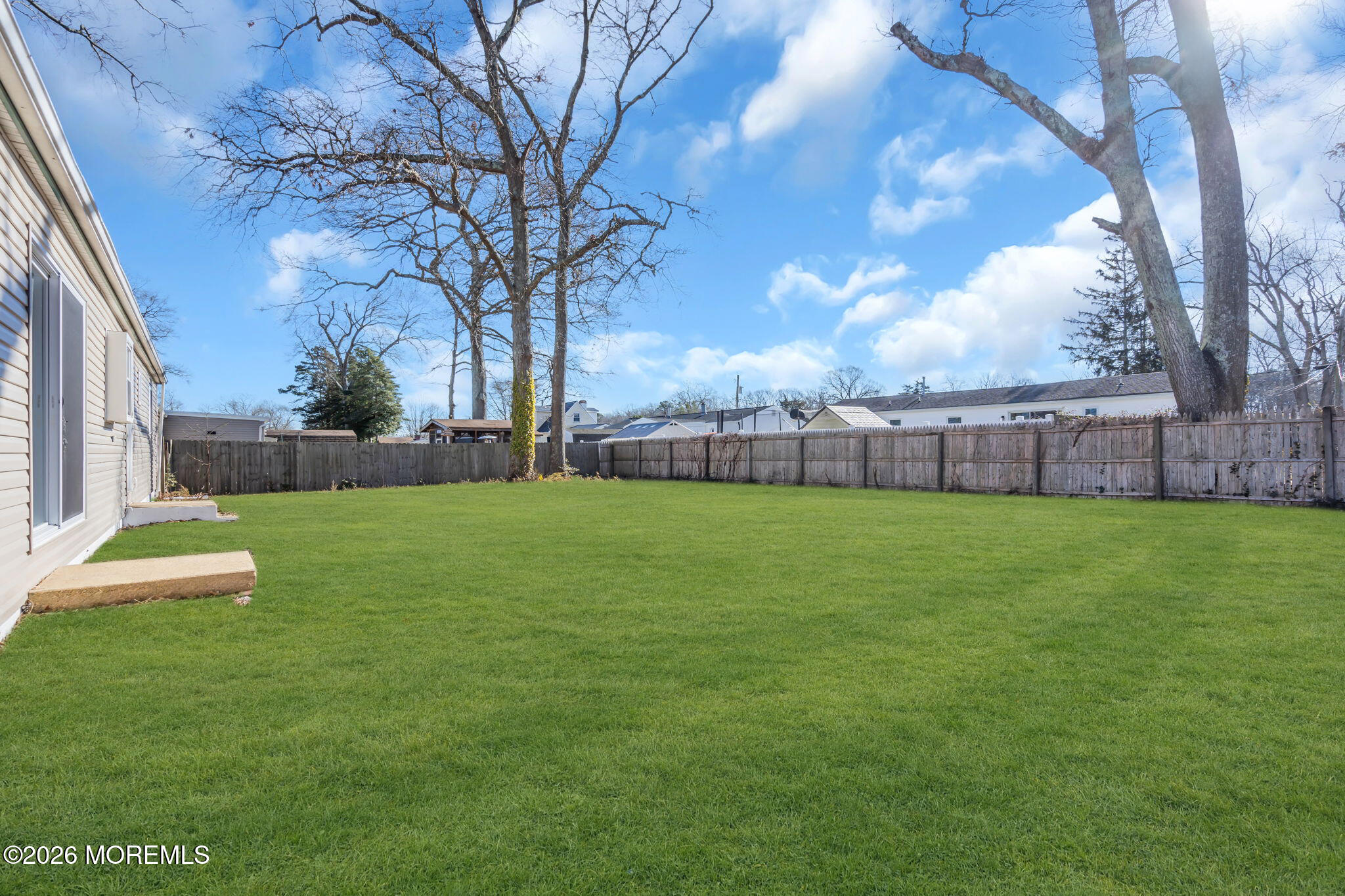 a view of yard with grass and trees