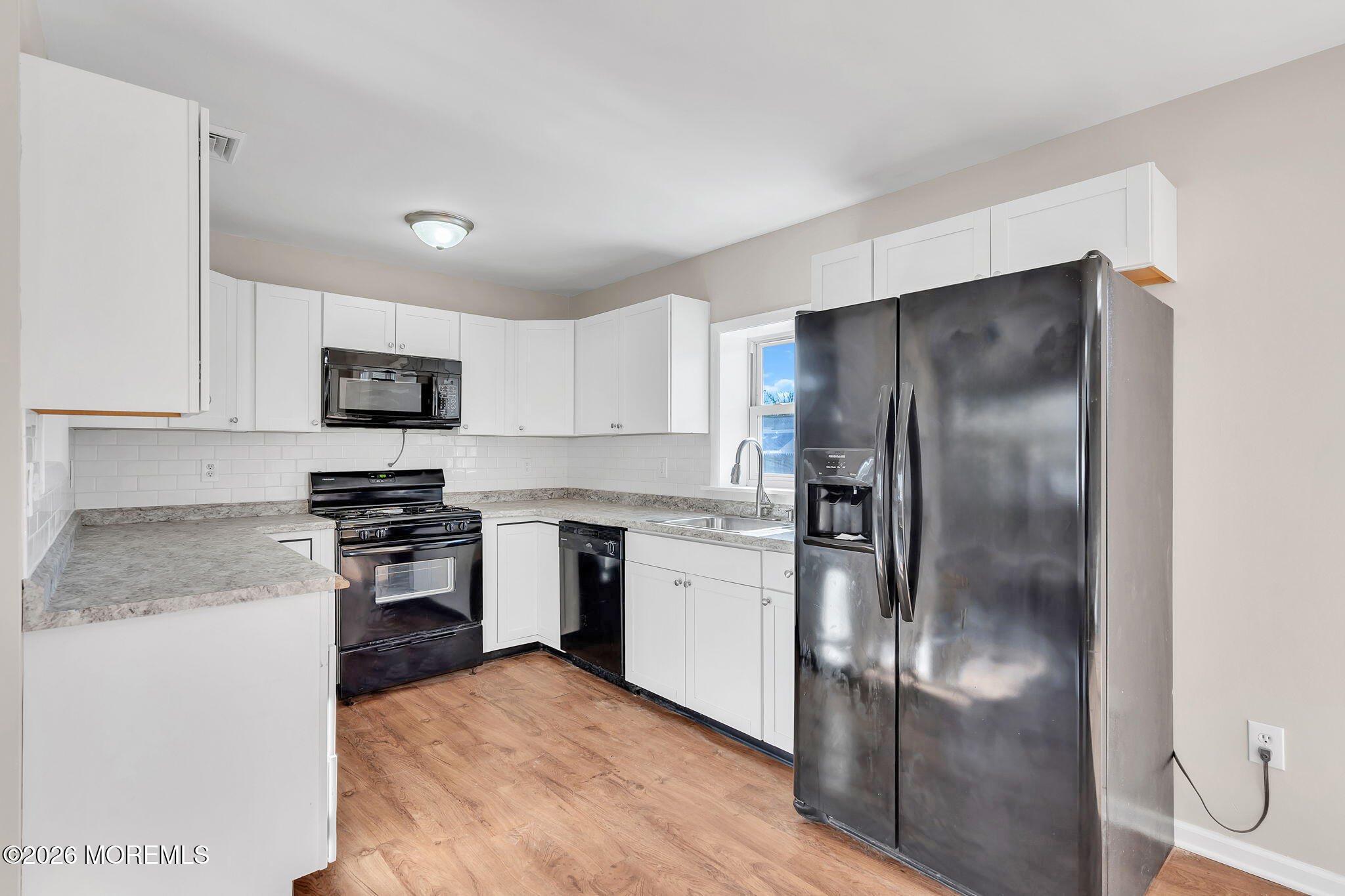 34 Dockage Road Bayville, NJ 08721 - Photo 19 of 31 a kitchen with a refrigerator and a stove top oven