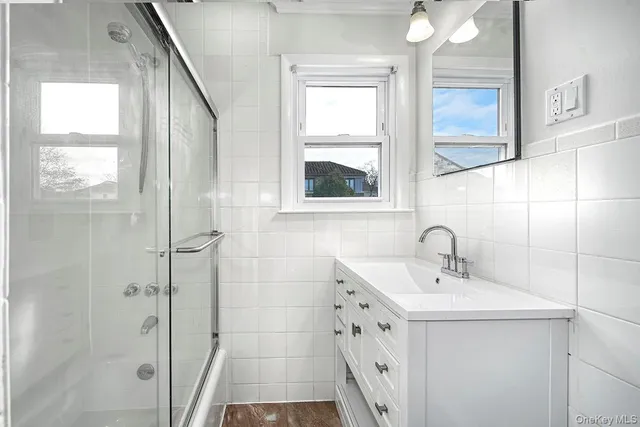 a bathroom with a sink a mirror and a shower