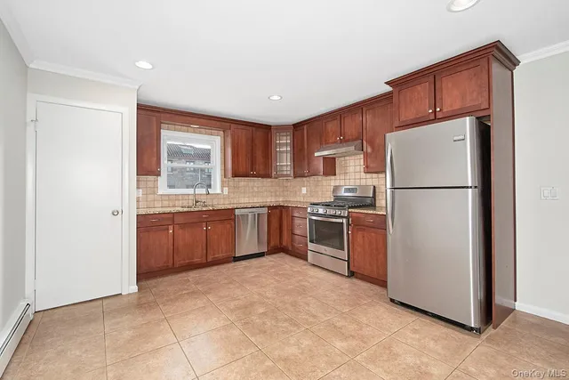 a kitchen with stainless steel appliances granite countertop a refrigerator sink and cabinets