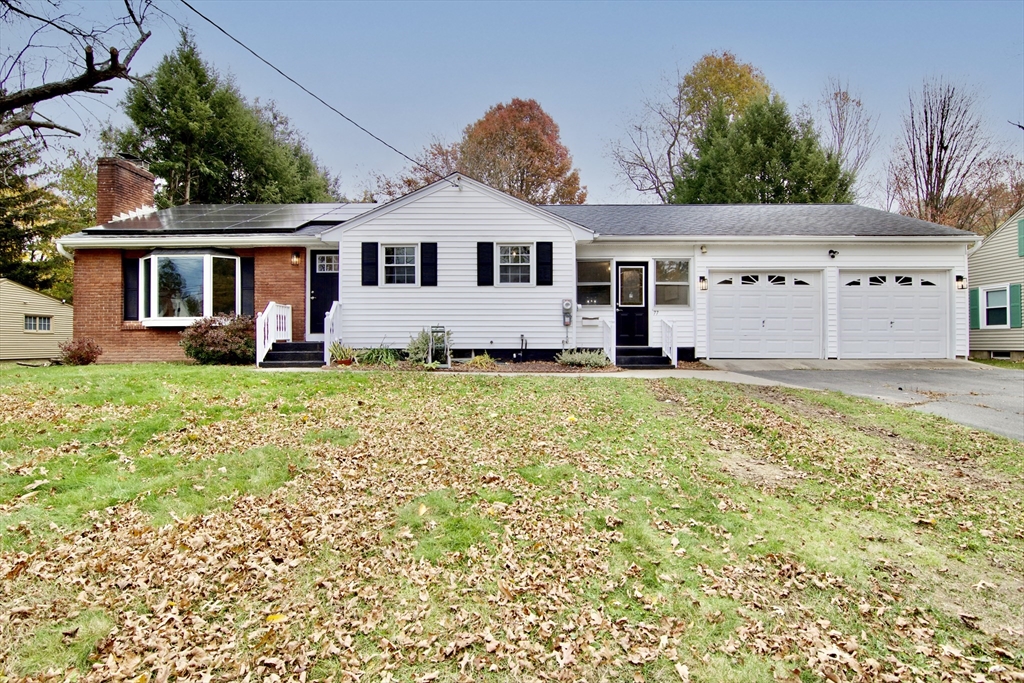 a front view of a house with a yard