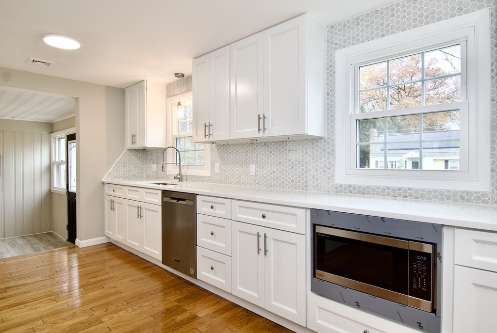 77 West Allen Ridge Road Springfield, MA 01118 - Photo 11 of 42 a kitchen with granite countertop white cabinets and white appliances