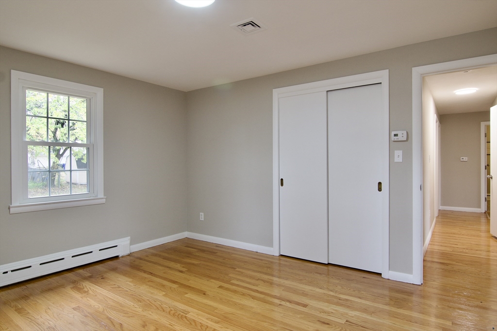 77 West Allen Ridge Road Springfield, MA 01118 - Photo 25 of 42 a view of an empty room with wooden floor and a window