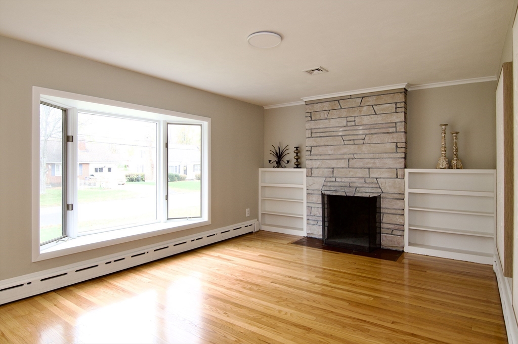 77 West Allen Ridge Road Springfield, MA 01118 - Photo 6 of 42 a view of an empty room with a fireplace and a window