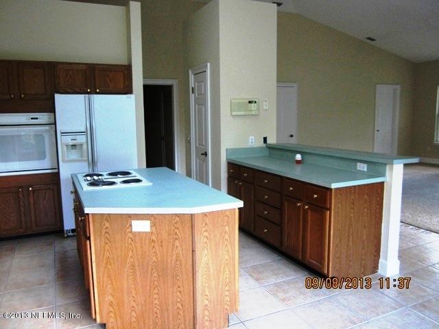 2026 Cornell Road Middleburg, FL 32068 - Photo 9 of 26 a kitchen with a stove a refrigerator and a sink
