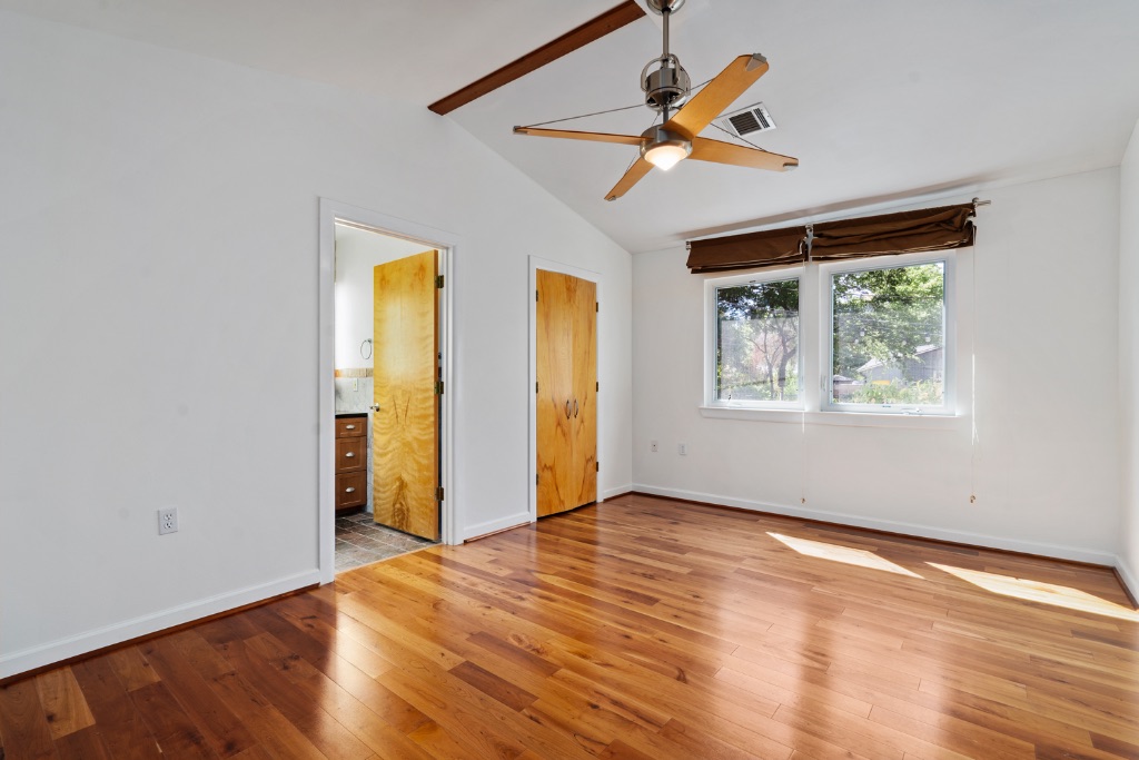 1212 Bentwood Road Austin, TX 78722 - Photo 22 of 32 a view of an empty room with window and wooden floor