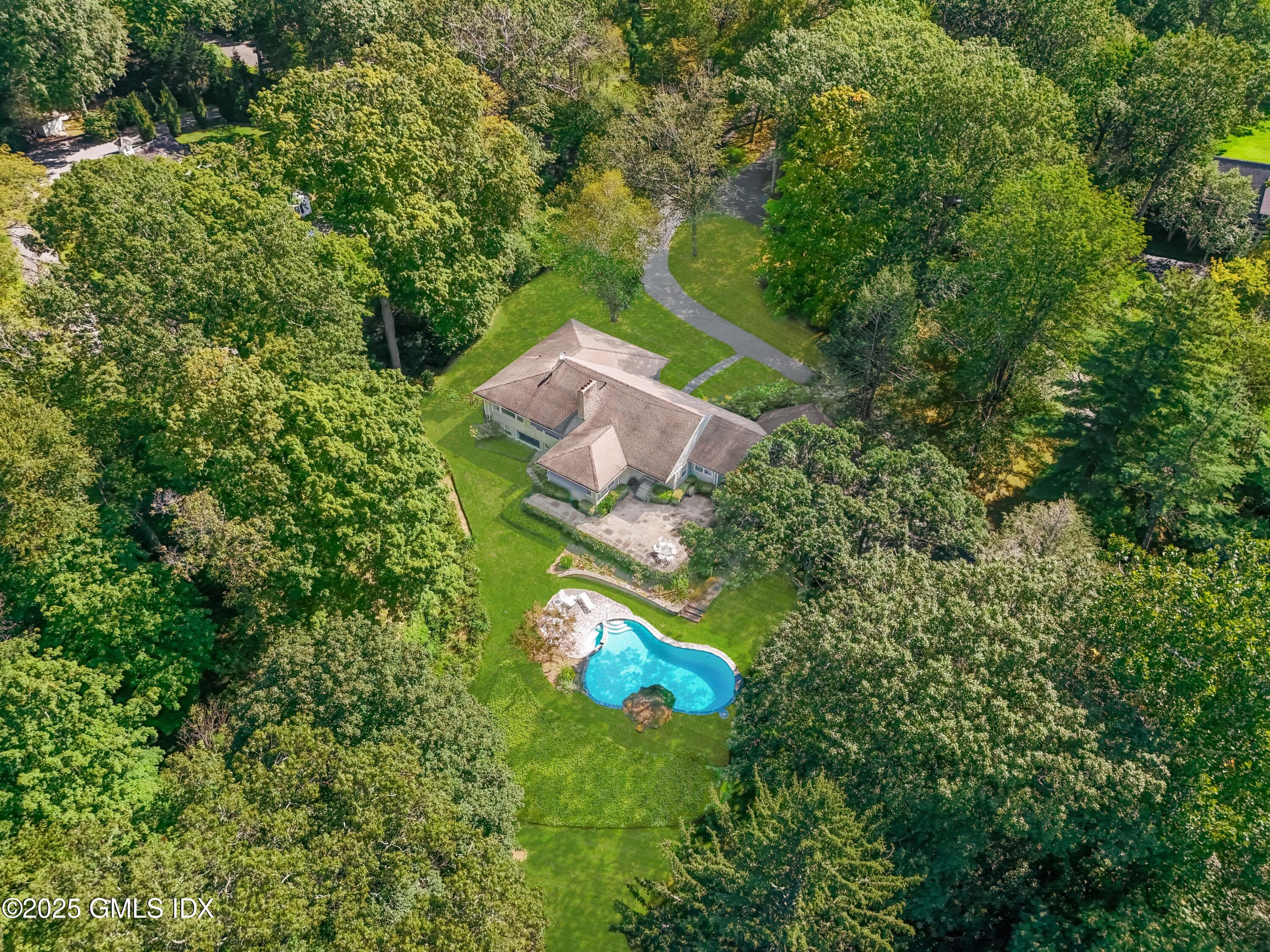 an aerial view of a house with a yard