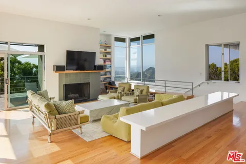 a living room with fireplace a flat screen tv and a fireplace