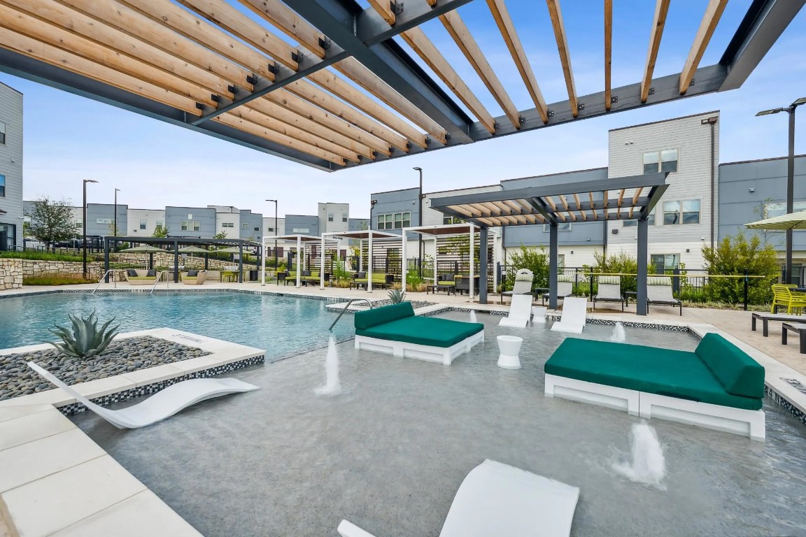 10350 Blue Bluff Road, Unit 14102 Austin, TX 78724 - Photo 26 of 27 a view of a swimming pool with outdoor seating and plants