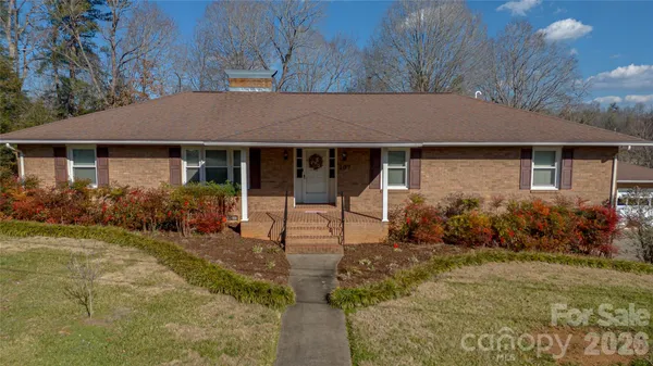 a front view of house with yard and green space