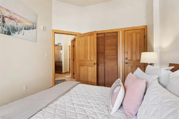 a bedroom with a bed and a lamp