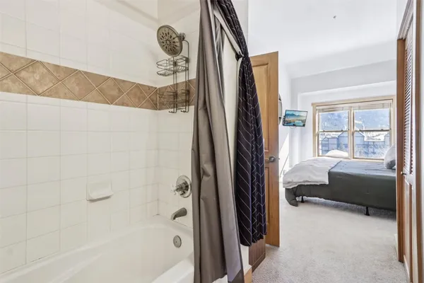 a bathroom with a tub and a window