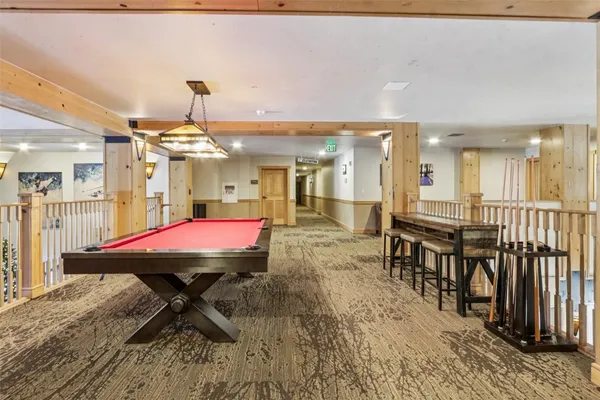 a view of a big room with table & chairs