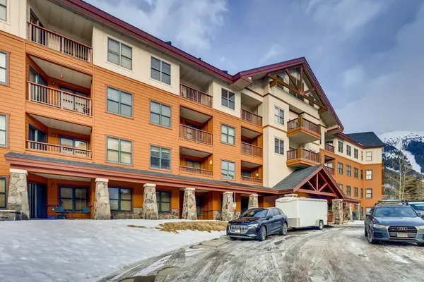 a front view of a building and car parked