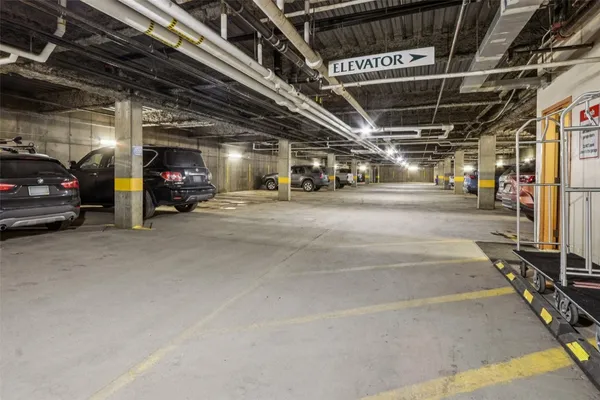 a view of parking garage with cars
