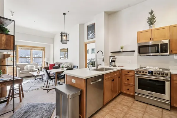 a kitchen with a stove a sink and a refrigerator