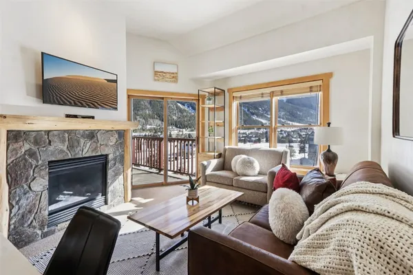 a living room with furniture fireplace and flat screen tv