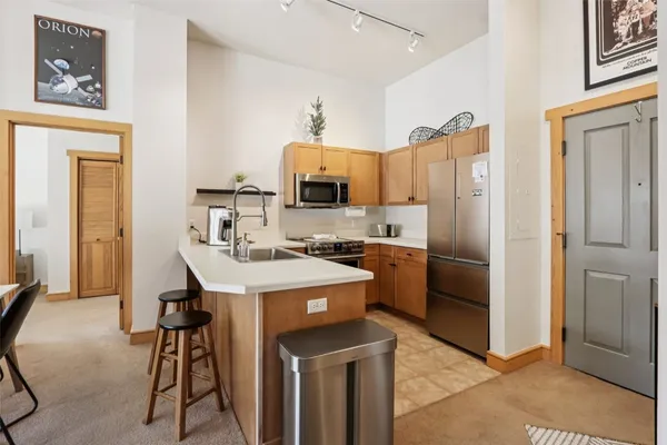 a kitchen with stainless steel appliances a stove a refrigerator and a refrigerator