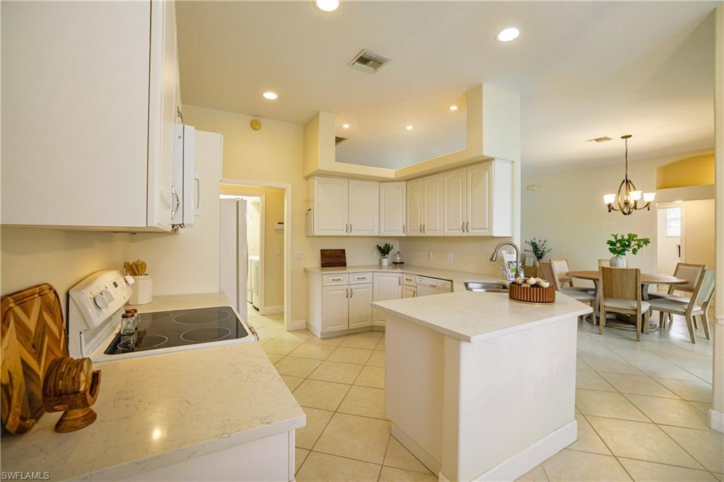 5235 Malvern Court Naples, FL 34112 - Photo 10 of 28 a kitchen with a sink a counter top space and appliances