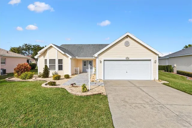 a view of a house with a yard and garage