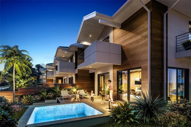 a view of a house with backyard water fountain and sitting area