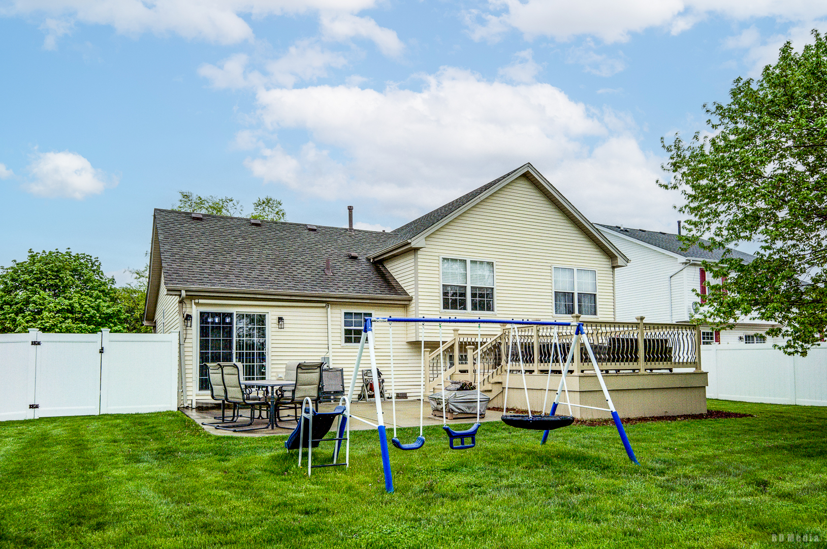 25606 Jonquil Lane Monee, IL 60449 - Photo 31 of 38 a white house with a big yard and table and chairs with wooden fence