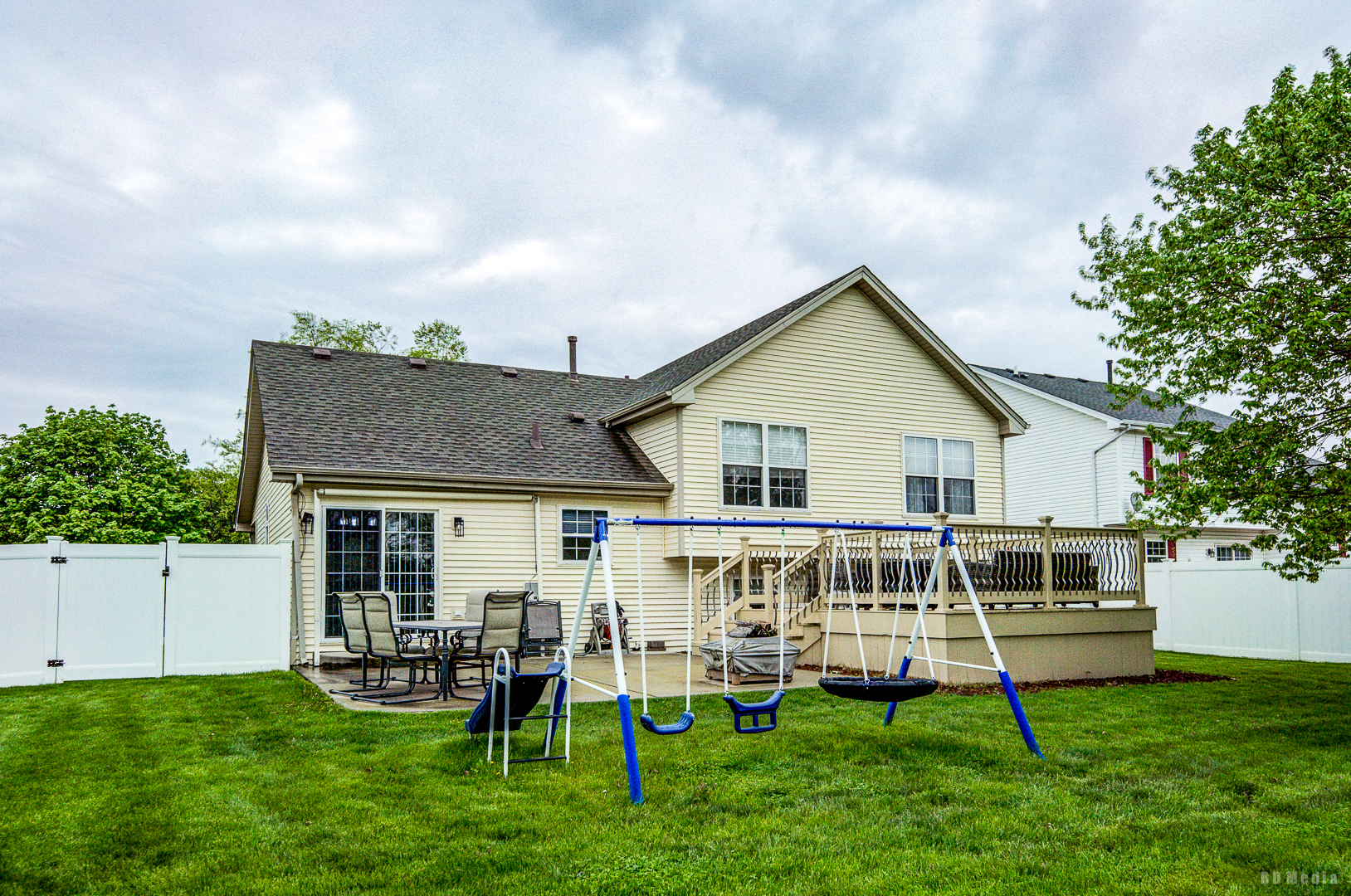 25606 Jonquil Lane Monee, IL 60449 - Photo 37 of 38 a white house with a big yard and table and chairs with wooden fence