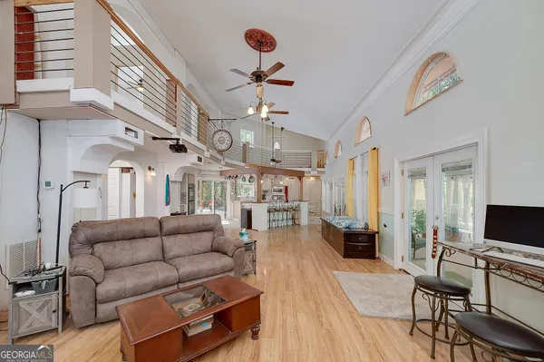 a kitchen with stainless steel appliances granite countertop a refrigerator a stove and a wooden floors