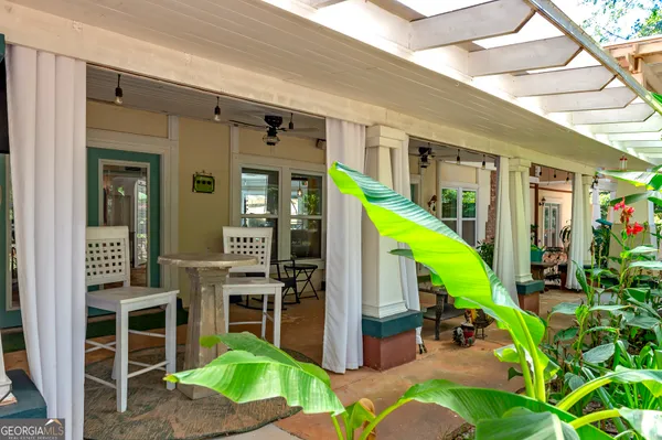 a living room filled with furniture and a potted plant