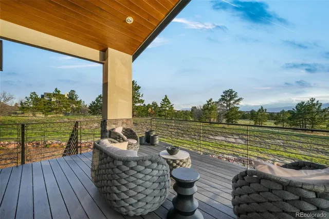 a roof deck with outdoor seating and ocean view