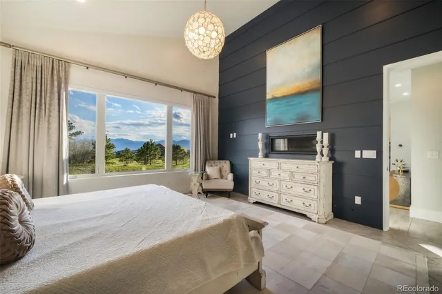 a bedroom with a large bed and a large window