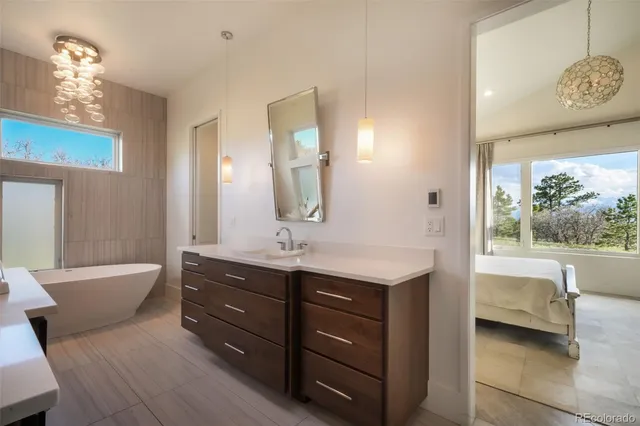a spacious bathroom with a granite countertop tub sink and mirror