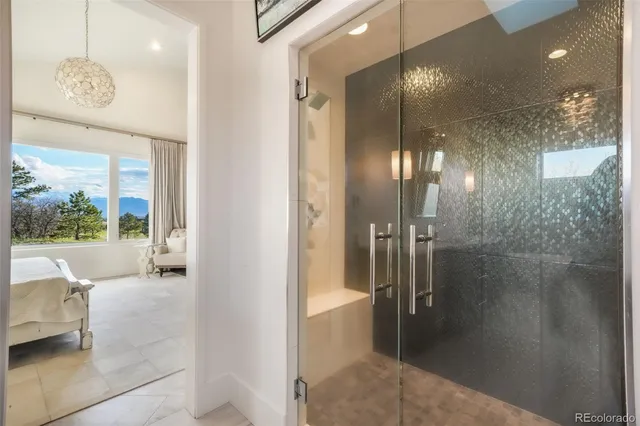 a bathroom with a glass shower door