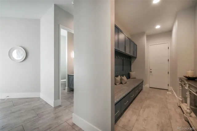 a bathroom with a granite countertop sink toilet and a mirror