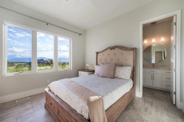 a bedroom with a bed and a mirror